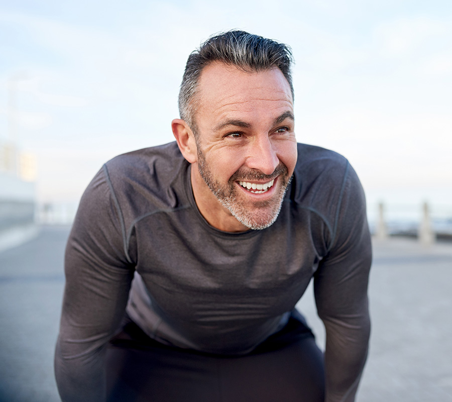 Man smiling after a run after receiving testosterone replacement therapy